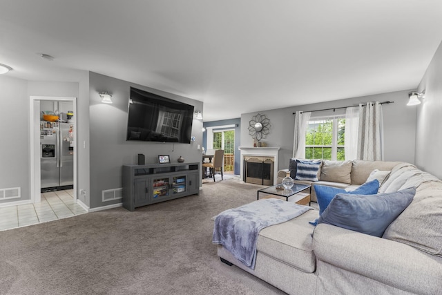 59 Colonial Ct, Streamwood, IL 60107 - living room with light carpet, a fireplace, and light tile patterned floors