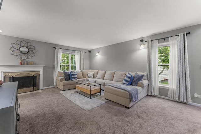 59 Colonial Ct, Streamwood, IL 60107 - living room featuring carpet flooring, healthy amount of natural light, and a fireplace with flush hearth