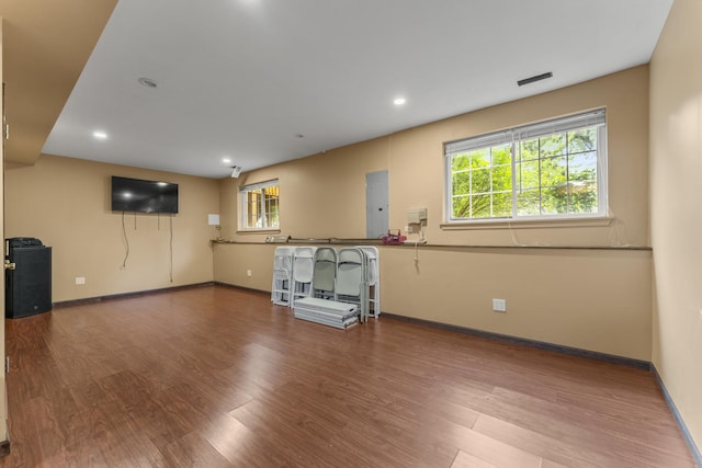 59 Colonial Ct, Streamwood, IL 60107 - unfurnished living room with wood finished floors, electric panel, and recessed lighting