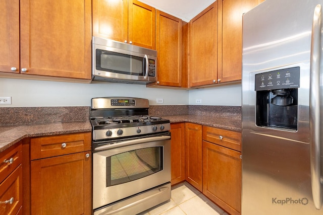 915 S Oak Park Ave Unit 1B, Oak Park, IL 60304 - kitchen with stainless steel appliances, brown cabinets, and dark stone counters