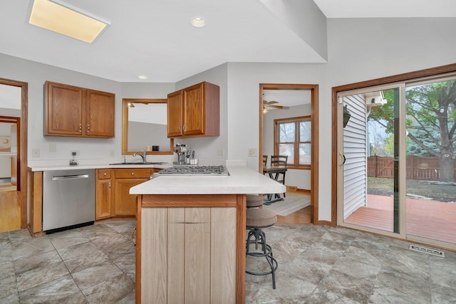 5209 Meadowbrook St, Plainfield, IL 60586 - kitchen with appliances with stainless steel finishes, light countertops, a kitchen bar, a peninsula, and brown cabinets