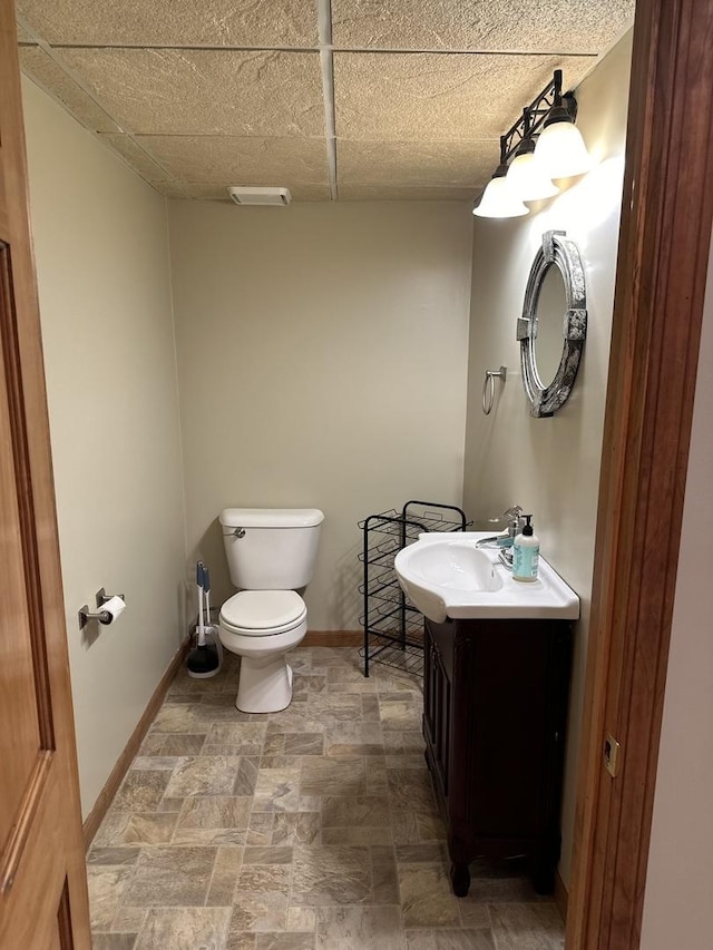 5209 Meadowbrook St, Plainfield, IL 60586 - half bath with vanity, stone finish floors, and a paneled ceiling