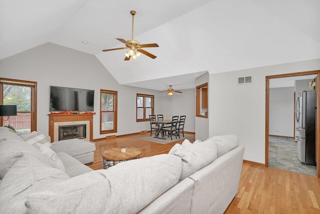 5209 Meadowbrook St, Plainfield, IL 60586 - living room with vaulted ceiling, light wood finished floors, ceiling fan, a fireplace, and healthy amount of natural light