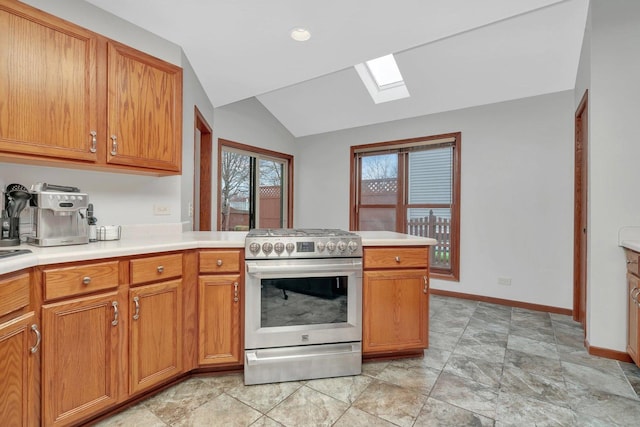 5209 Meadowbrook St, Plainfield, IL 60586 - kitchen featuring gas range, a skylight, vaulted ceiling, a peninsula, and light countertops