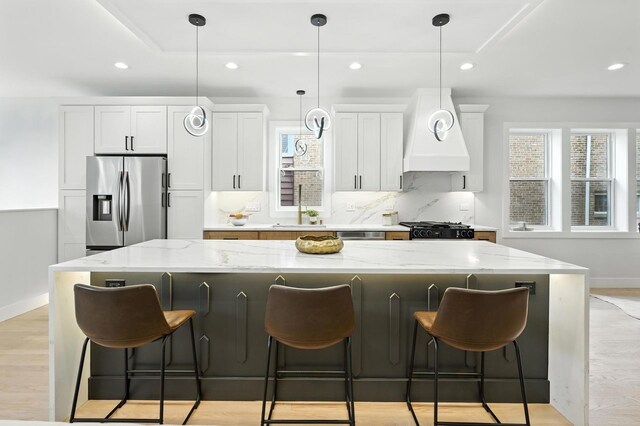 4630 N Kasson Ave, Chicago, IL 60630 - kitchen featuring stainless steel fridge with ice dispenser, recessed lighting, a large island, white cabinetry, and custom range hood