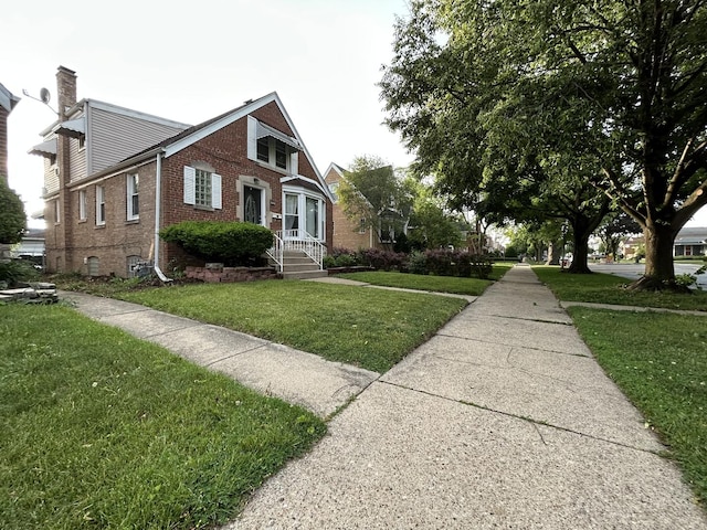 1636 N 75th Ave, Elmwood Park, IL 60707 - view of front of house with brick siding and a front lawn