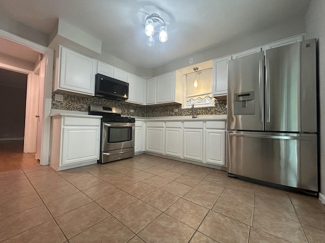 1636 N 75th Ave, Elmwood Park, IL 60707 - kitchen featuring stainless steel appliances, backsplash, light tile patterned floors, and white cabinets