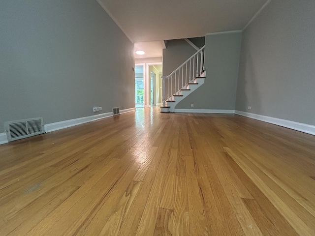1636 N 75th Ave, Elmwood Park, IL 60707 - unfurnished living room with wood finished floors, stairs, and crown molding