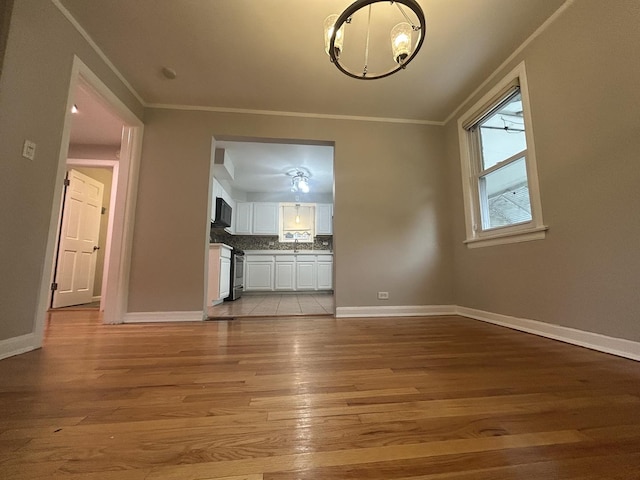 1636 N 75th Ave, Elmwood Park, IL 60707 - unfurnished living room featuring ornamental molding, light wood-style flooring, and a chandelier