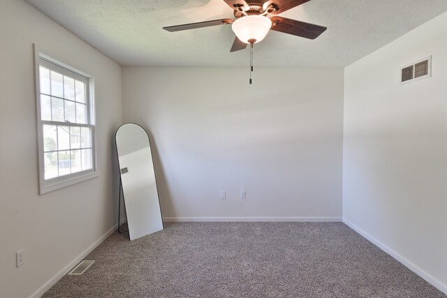 1409 N Nixon Dr, Pontiac, IL 61764 - carpeted spare room featuring a ceiling fan and baseboards