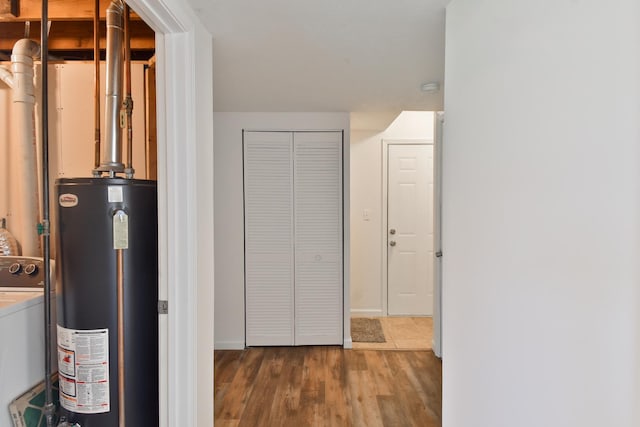 1409 N Nixon Dr, Pontiac, IL 61764 - hall featuring gas water heater, washer / dryer, and wood finished floors