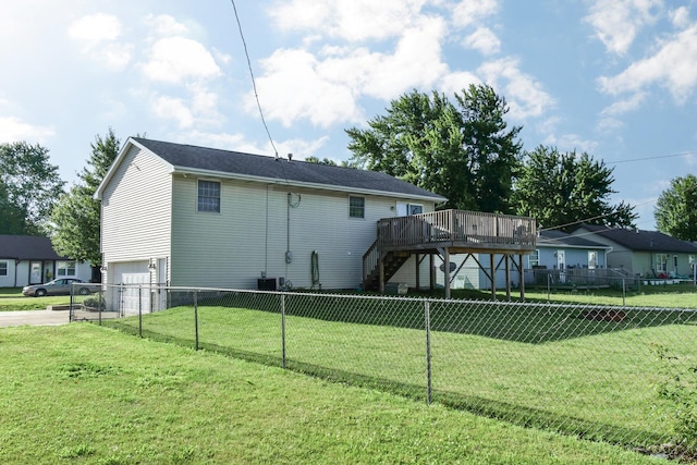 1409 N Nixon Dr, Pontiac, IL 61764 - back of property with stairs, a deck, driveway, an attached garage, and a fenced backyard
