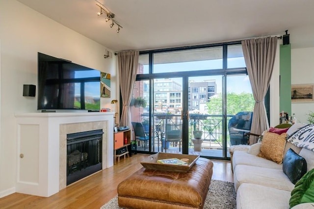 3232 N Halsted St Unit D412, Chicago, IL 60657 - living area with light wood finished floors, expansive windows, and a tiled fireplace