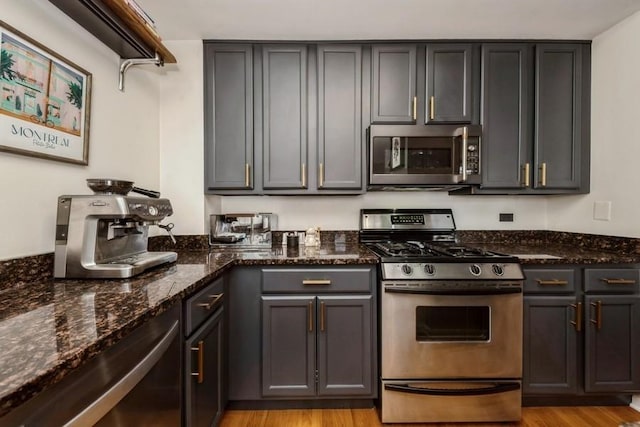 3232 N Halsted St Unit D412, Chicago, IL 60657 - kitchen with appliances with stainless steel finishes, light wood-type flooring, and dark stone counters