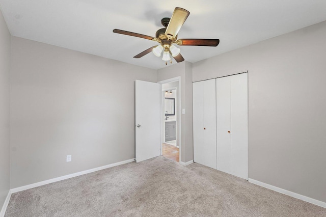 809 S Longview Rd, Monticello, IL 61856 - unfurnished bedroom featuring carpet floors, a closet, and a ceiling fan