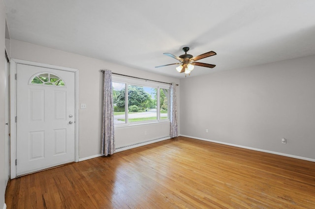 809 S Longview Rd, Monticello, IL 61856 - entrance foyer with light wood-style floors, a baseboard radiator, and ceiling fan
