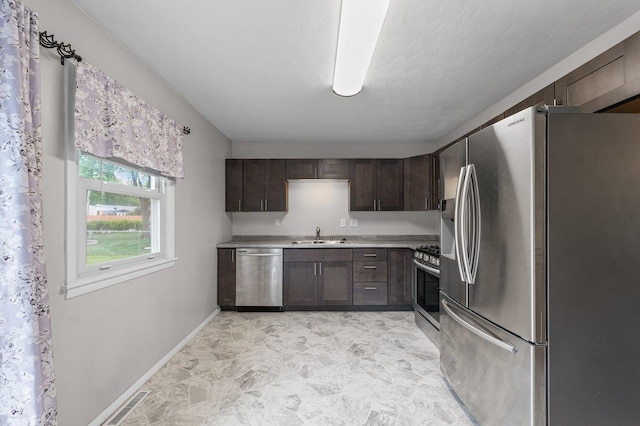 809 S Longview Rd, Monticello, IL 61856 - kitchen with stainless steel appliances, light countertops, and dark brown cabinets