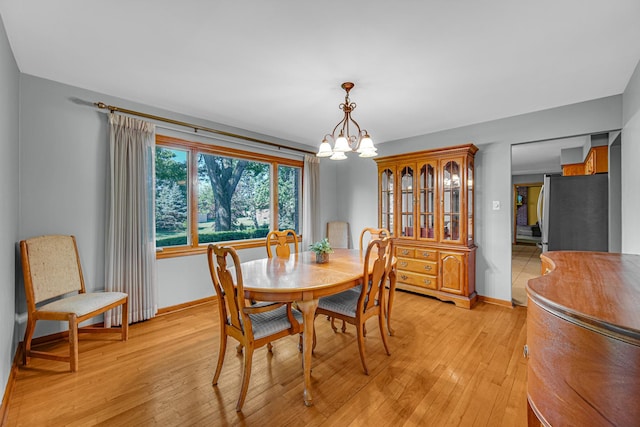 8353 Arrowhead Ln, Orland Park, IL 60462 - dining space with a chandelier and light wood-type flooring
