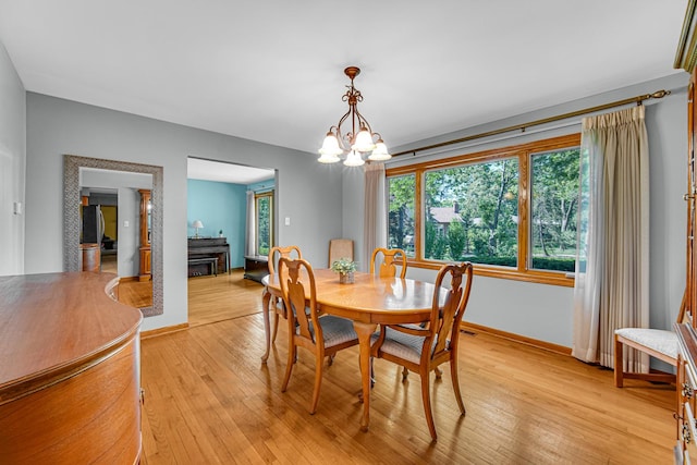 8353 Arrowhead Ln, Orland Park, IL 60462 - dining room featuring light wood-type flooring and a chandelier