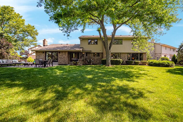 8353 Arrowhead Ln, Orland Park, IL 60462 - back of property featuring brick siding, a chimney, a patio area, and a yard