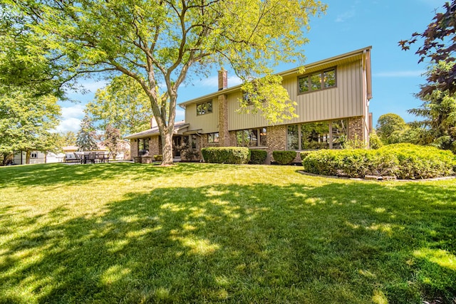 8353 Arrowhead Ln, Orland Park, IL 60462 - back of property with a chimney, a yard, and brick siding