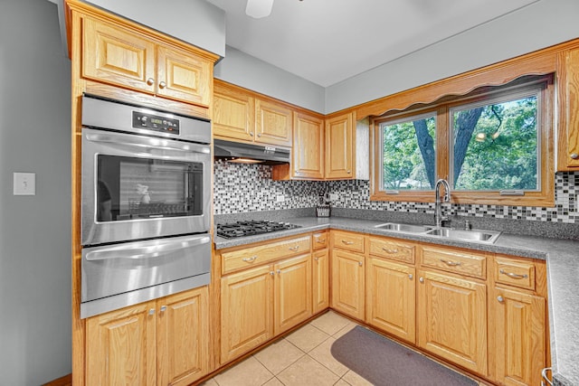 8353 Arrowhead Ln, Orland Park, IL 60462 - kitchen with a warming drawer, oven, gas stovetop, under cabinet range hood, and backsplash