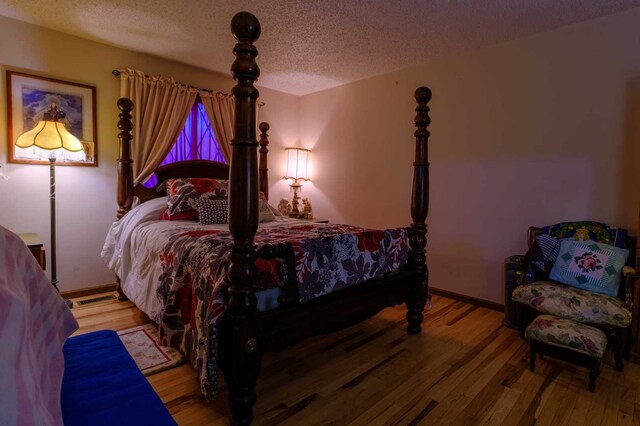 921 Shagbark Rd Unit 921, New Lenox, IL 60451 - bedroom featuring wood finished floors and a textured ceiling