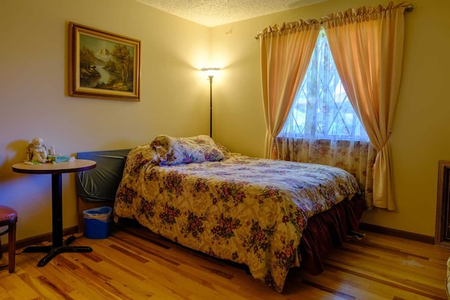 921 Shagbark Rd Unit 921, New Lenox, IL 60451 - bedroom with light wood-type flooring and a textured ceiling