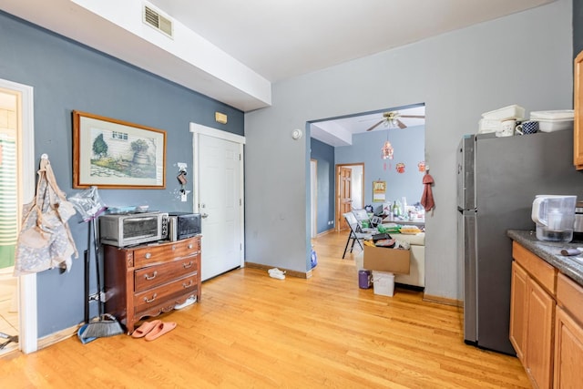 2958 S Lowe Ave, Chicago, IL 60616 - kitchen featuring freestanding refrigerator, light wood finished floors, a ceiling fan, and dark countertops