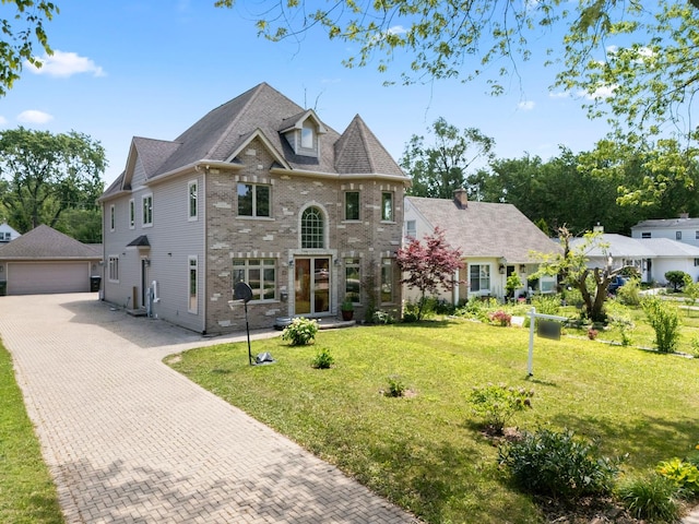 23 S Elm St, Palatine, IL 60067 - view of front of house with an outbuilding, brick siding, a garage, and a front lawn