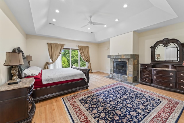 23 S Elm St, Palatine, IL 60067 - bedroom featuring a raised ceiling, light wood finished floors, a tile fireplace, a ceiling fan, and recessed lighting