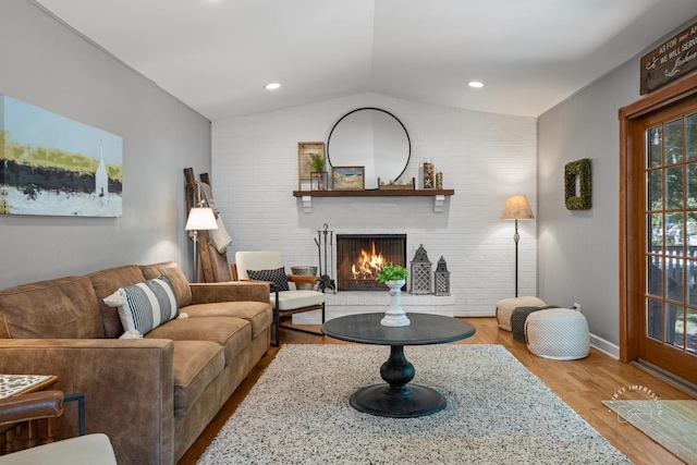 302 Carriage Hill Rd, Naperville, IL 60565 - living area with lofted ceiling, a brick fireplace, brick wall, and wood finished floors