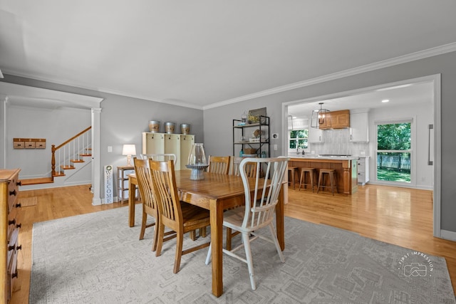 302 Carriage Hill Rd, Naperville, IL 60565 - dining room with light wood-type flooring, crown molding, and stairway