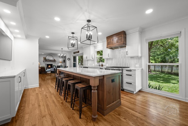 302 Carriage Hill Rd, Naperville, IL 60565 - kitchen with a chandelier, white cabinetry, recessed lighting, a spacious island, and stainless steel range
