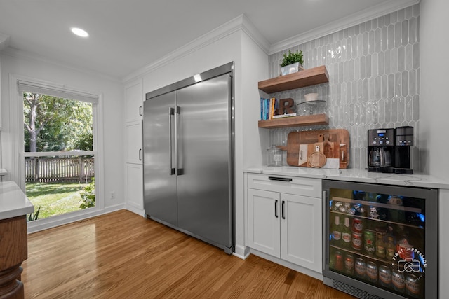 302 Carriage Hill Rd, Naperville, IL 60565 - kitchen with stainless steel built in fridge, beverage cooler, crown molding, light wood-style floors, and white cabinets
