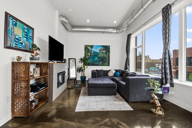 1375 N Milwaukee Ave Unit 3F, Chicago, IL 60622 - living room featuring finished concrete floors, a glass covered fireplace, a high ceiling, and recessed lighting