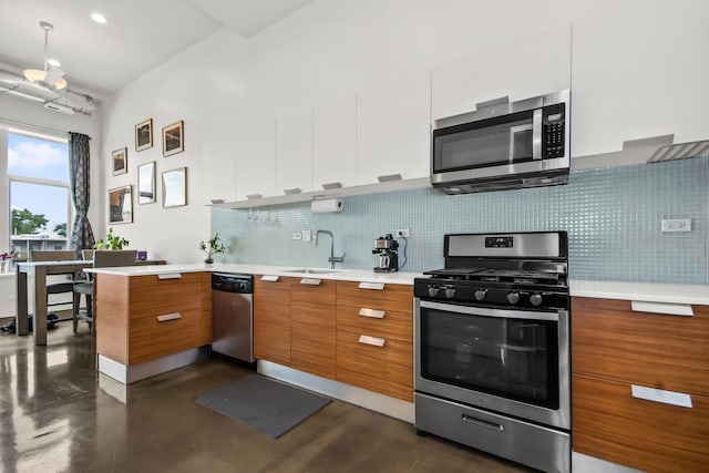 1375 N Milwaukee Ave Unit 3F, Chicago, IL 60622 - kitchen featuring appliances with stainless steel finishes, modern cabinets, brown cabinetry, tasteful backsplash, and light countertops