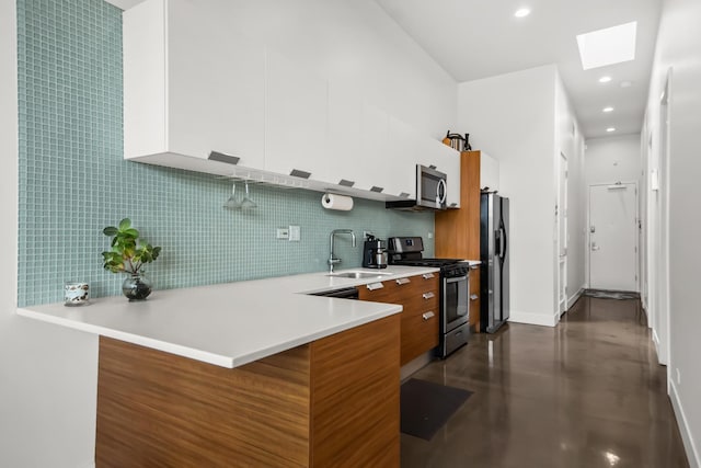 1375 N Milwaukee Ave Unit 3F, Chicago, IL 60622 - kitchen with appliances with stainless steel finishes, modern cabinets, a skylight, backsplash, and recessed lighting