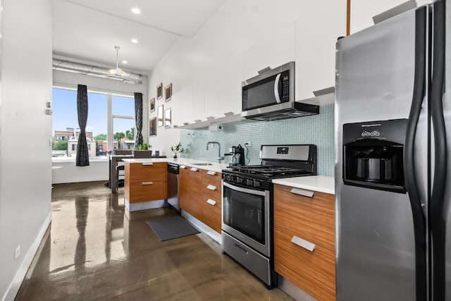 1375 N Milwaukee Ave Unit 3F, Chicago, IL 60622 - kitchen with appliances with stainless steel finishes, brown cabinetry, modern cabinets, concrete flooring, and light countertops