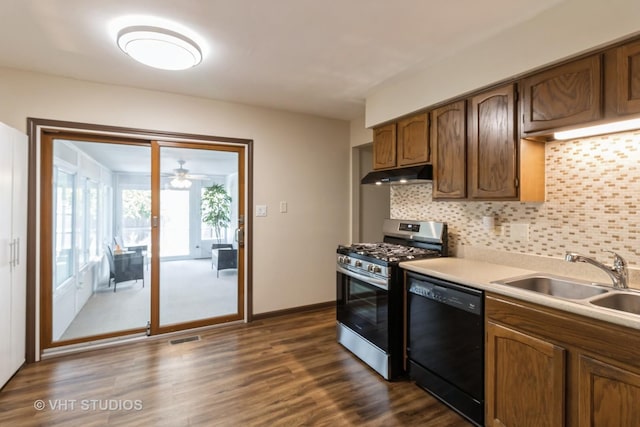 1942 Trail Ridge St, Arlington Heights, IL 60004 - kitchen with black dishwasher, stainless steel range with gas cooktop, under cabinet range hood, backsplash, and dark wood-style flooring
