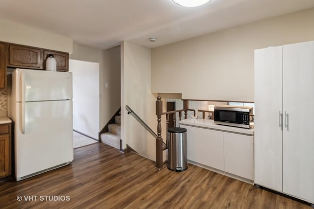 1942 Trail Ridge St, Arlington Heights, IL 60004 - kitchen with freestanding refrigerator, stainless steel microwave, dark wood-style flooring, and light countertops