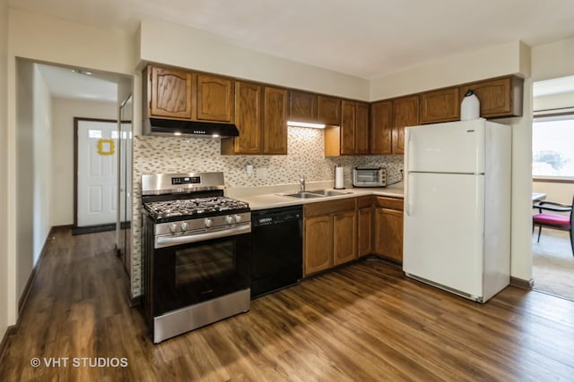 1942 Trail Ridge St, Arlington Heights, IL 60004 - kitchen with freestanding refrigerator, black dishwasher, stainless steel gas stove, under cabinet range hood, and dark wood-style floors