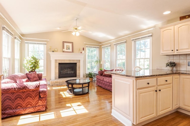 605 Ironwood Cc Dr, Normal, IL 61761 - living area with a ceiling fan, plenty of natural light, light wood finished floors, lofted ceiling, and a fireplace