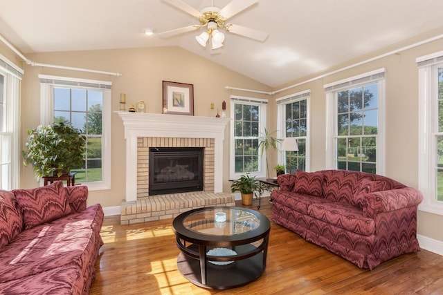 605 Ironwood Cc Dr, Normal, IL 61761 - living area with wood finished floors, vaulted ceiling, a ceiling fan, and a fireplace
