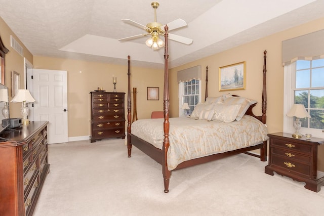 605 Ironwood Cc Dr, Normal, IL 61761 - bedroom with light colored carpet, a tray ceiling, and ceiling fan