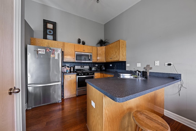 8331 W Chestnut Ct, Frankfort, IL 60423 - kitchen with stainless steel appliances, a peninsula, dark countertops, dark wood-style floors, and a towering ceiling