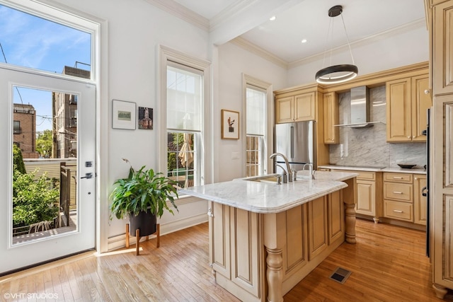 2249 W Warren Blvd, Chicago, IL 60612 - kitchen with wall chimney exhaust hood, stainless steel refrigerator, plenty of natural light, light wood-style flooring, and crown molding