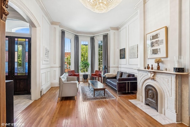 2249 W Warren Blvd, Chicago, IL 60612 - living room featuring a decorative wall, light wood-style flooring, a chandelier, and crown molding