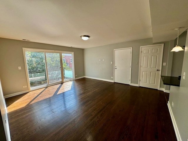6433 N Damen Ave Unit 3E, Chicago, IL 60645 - empty room featuring dark wood finished floors and baseboards