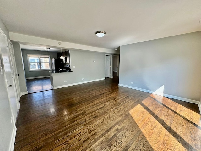 6433 N Damen Ave Unit 3E, Chicago, IL 60645 - empty room featuring dark wood finished floors and baseboards